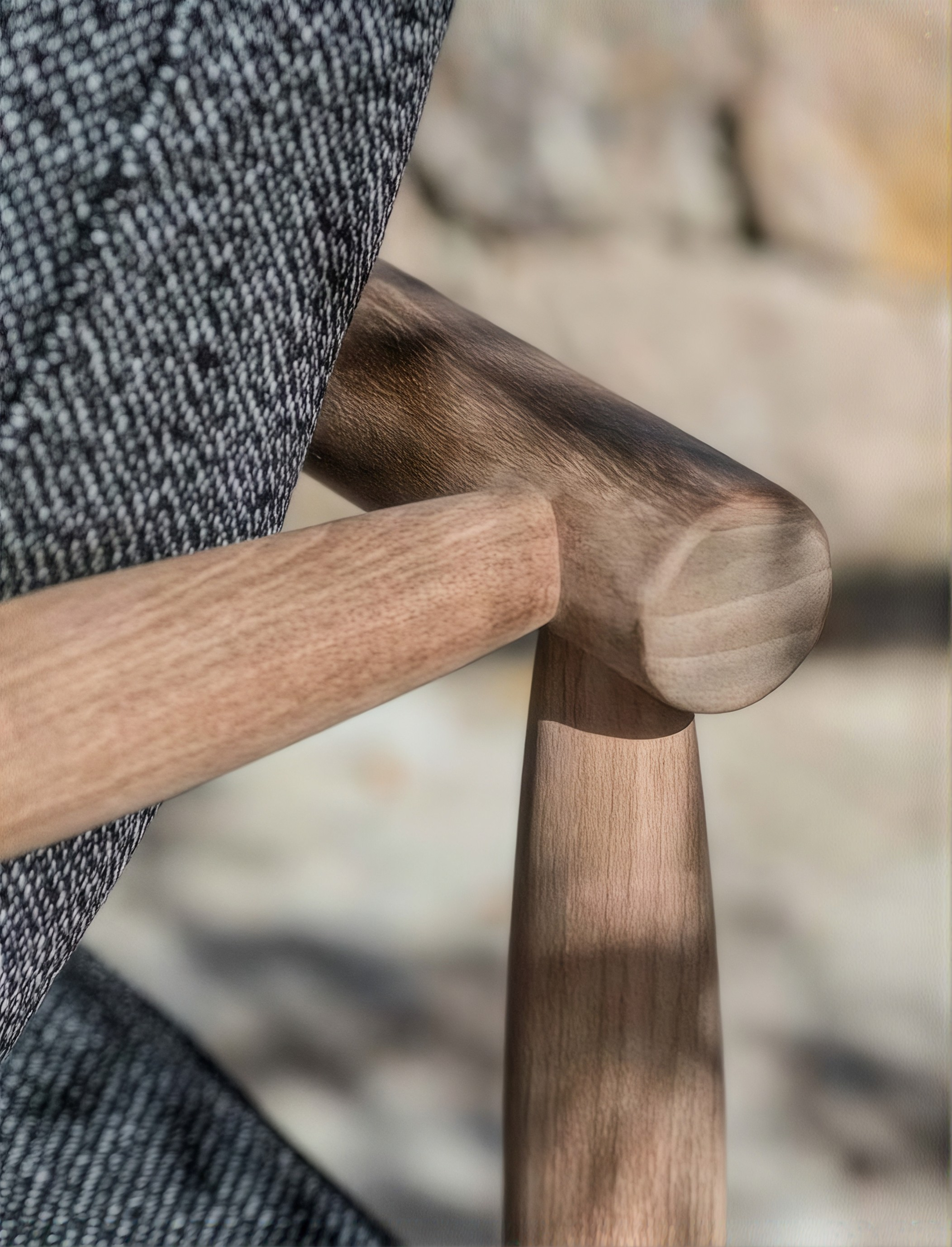 Close-up of a timber chair joint and woven upholstery
