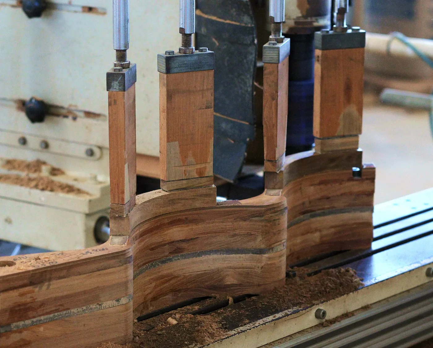 Laminated armrest blanks clamped on the CNC line