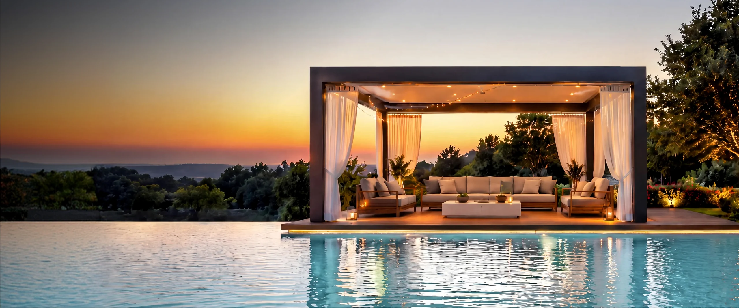 Furnished poolside pavilion glowing at sunset