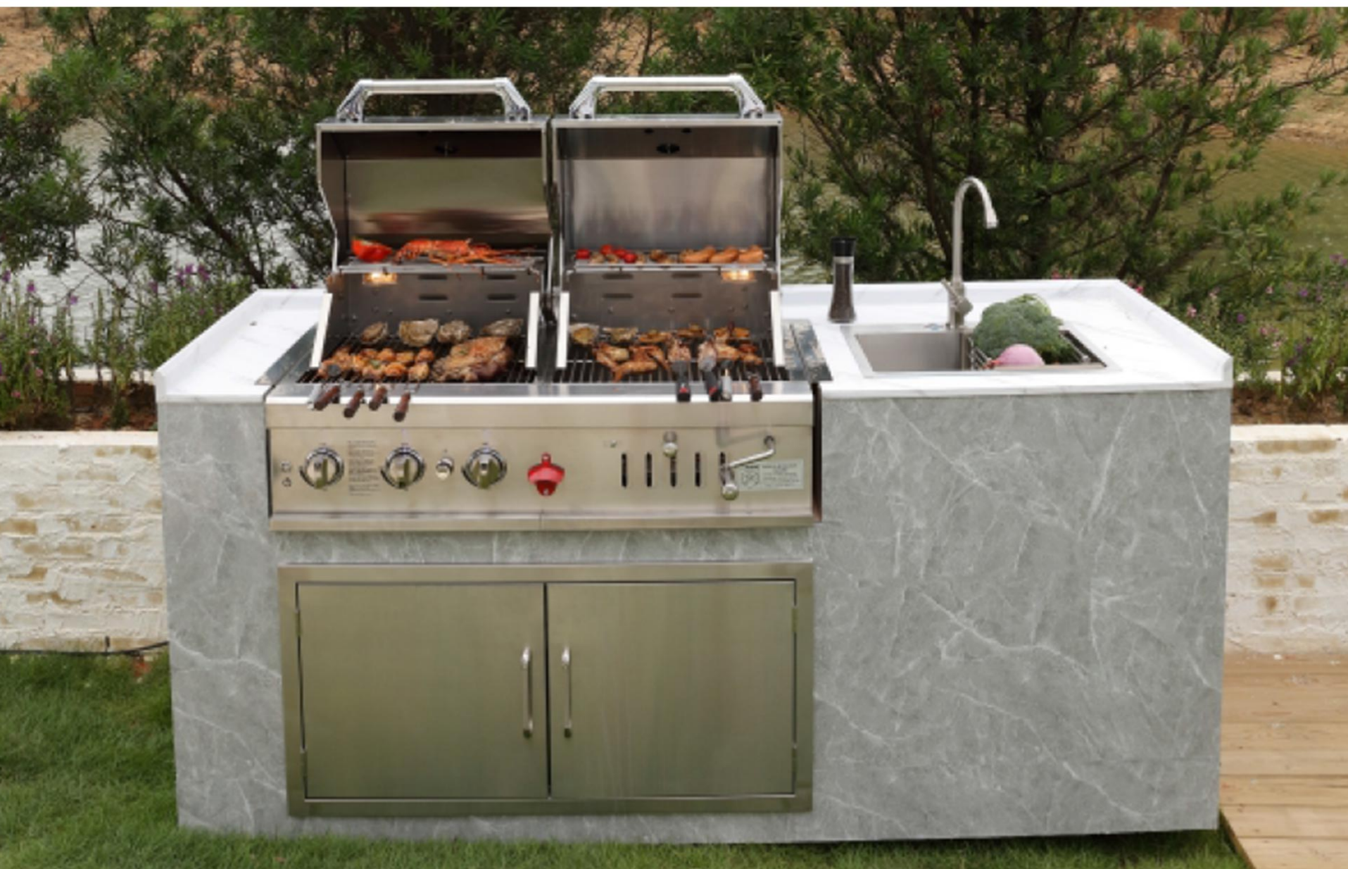 Green outdoor kitchen against a garden wall